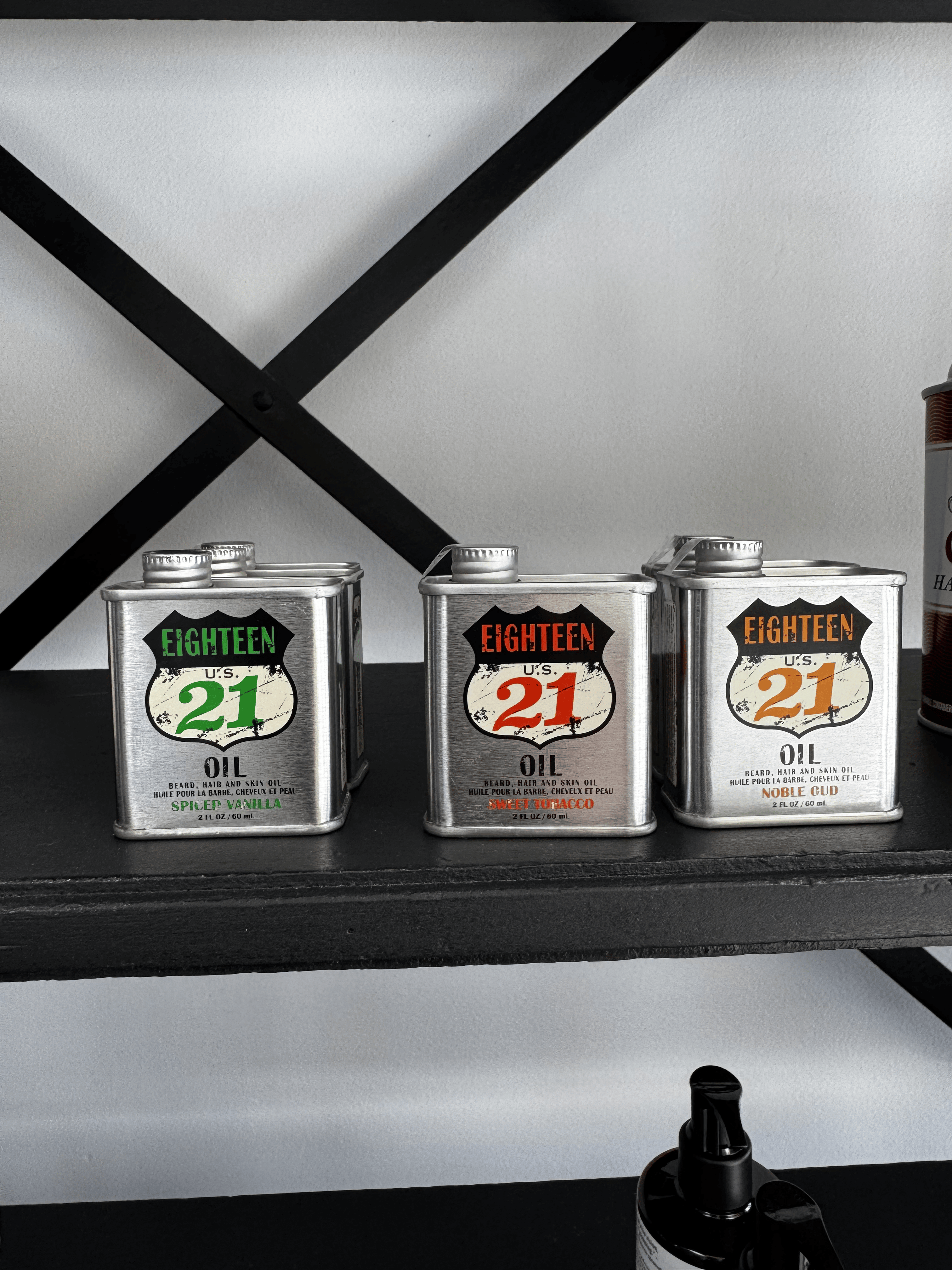 Eighteen 21 beard and skin oils displayed on shelf