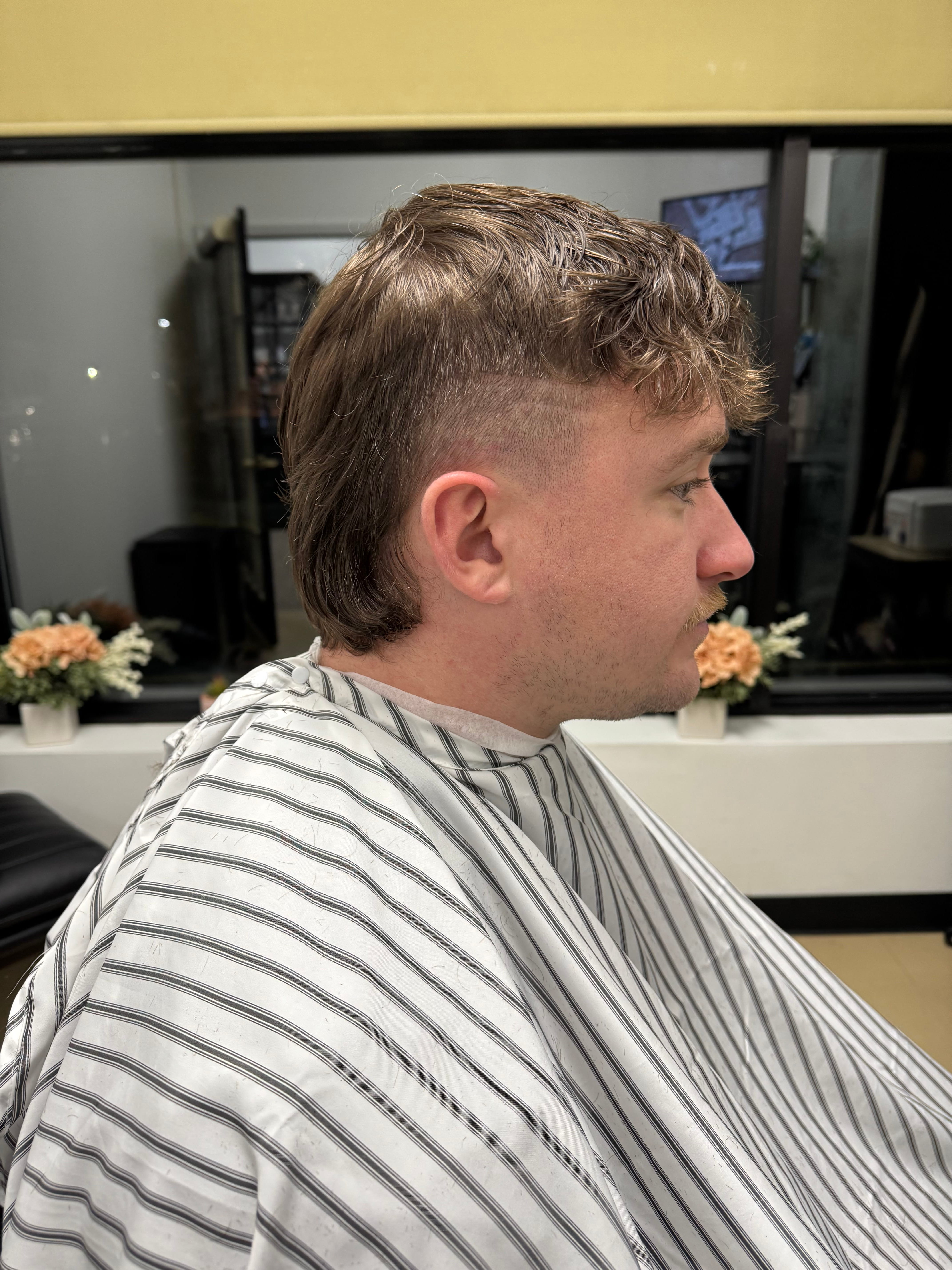 Short haircut profile with clean fade at 88 Mane Street